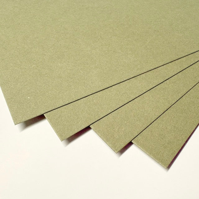 Four textured sheets of olive green craft paper or cardstock fanned out on a plain white background.