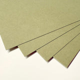 Four textured sheets of olive green craft paper or cardstock fanned out on a plain white background.